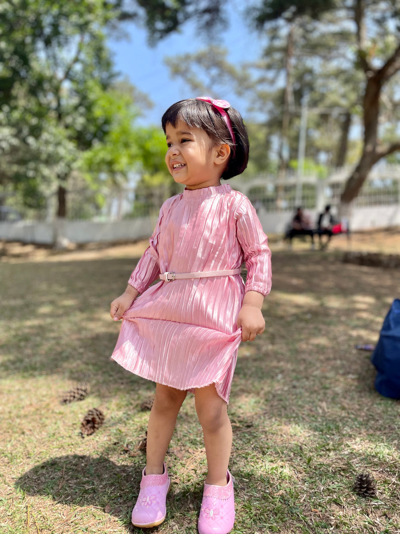 Girl wearing pink three fouth sleeves dress with pink belt and pink shoes