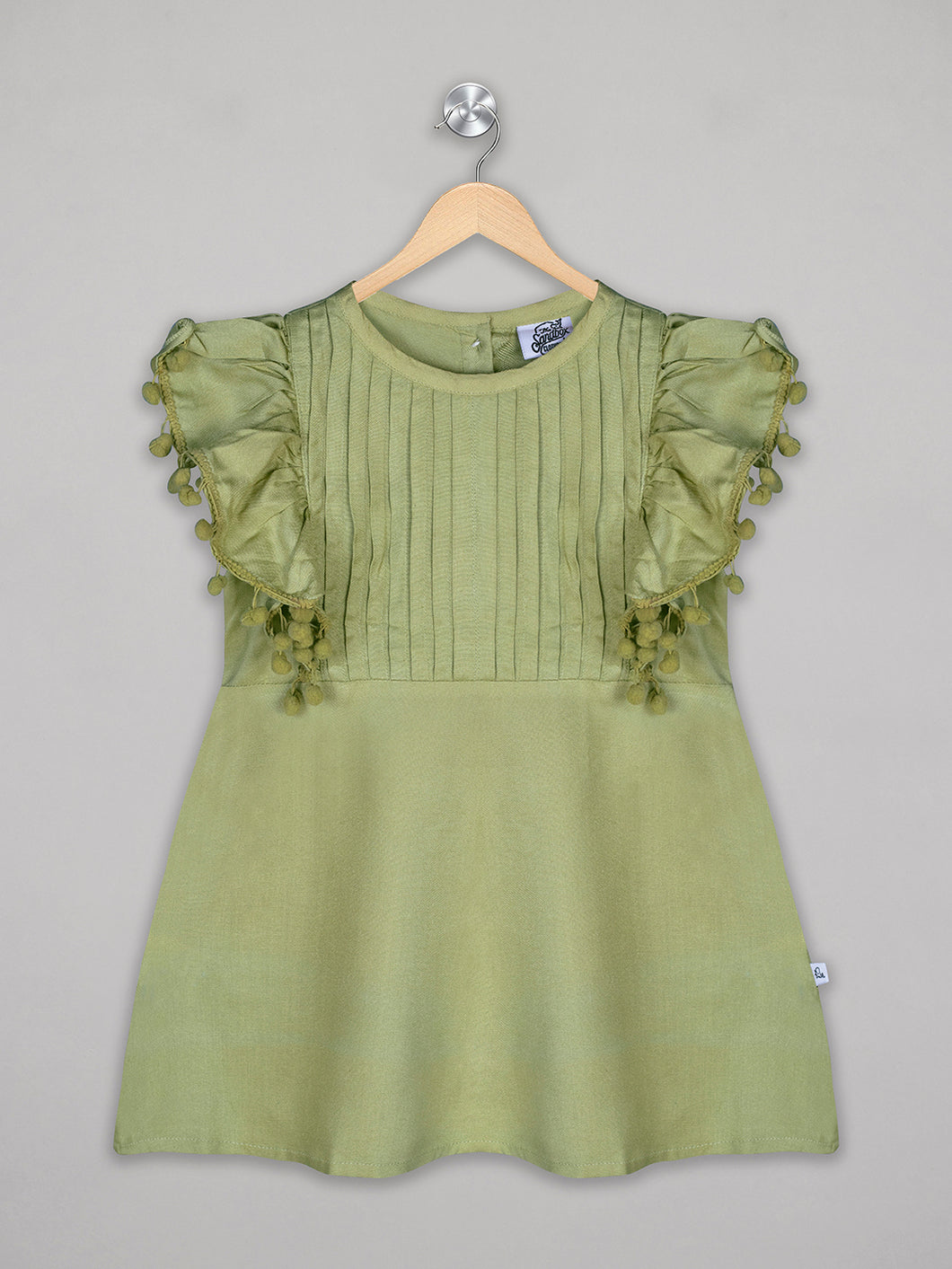 Solid green knee length dress for girls with pom pom detailing