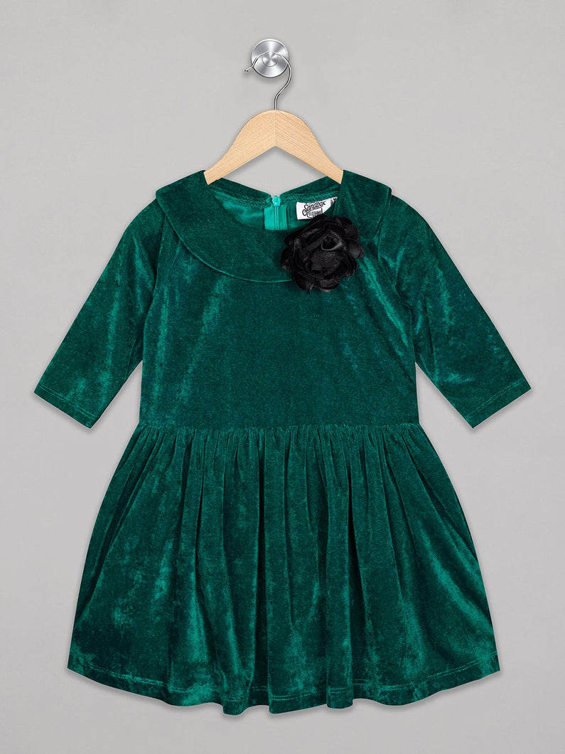 Green color 3/4th sleeves velvet party frock for girls with black flower attachment on the neck